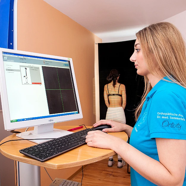 Mitarbeiterin führt eine 4D-Haltungsanalyse am Computer durch